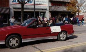 Terry Woster, with wife Nancy, rides in a chilly 1995 Hobo Day parade Distinguished Alumnus. He says it is better to be cold than to be dressed like Rocky Racoon, which is what he felt like the last time he was in the parade.