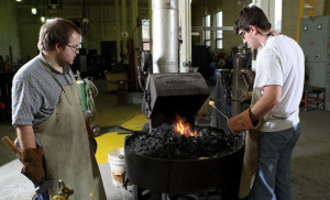 The forge in the blacksmithing shop of Solberg Hall runs hot for engineering students Logan Janssen, right, and Chad Guzinski as they work on their blacksmithing creation. 