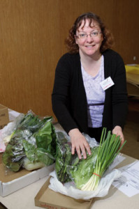South Dakota Local Foods Cooperative member Elizabeth Fox sorts greens that will be distributed the next day to those who have ordered them.