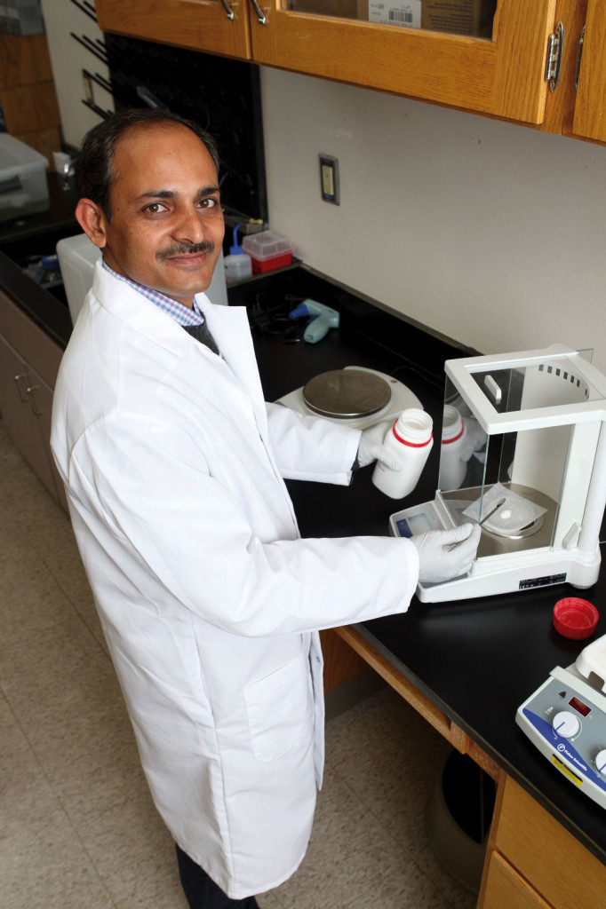 Visiting scientist Shahid Ahmed from India weighs agarose to prepare the electrophoresis gel, which he will load into the polymers chain reactor, or PCR, which uses electric current to separate the DNA into distinct bands, as part of his molecular work on leaf rust.
