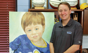 SDSUâ€ˆwomenâ€™s basketball coach Aaron Johnston with the painting of his son, Dylan, which Stuart created in 2013.