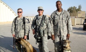 While in Jordan providing security for an exercise, Gacke poses with two dog handlers who were active duty members of the U.S. Air Force.
