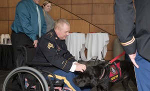 Bogue gives some attention to his service dog, Max.