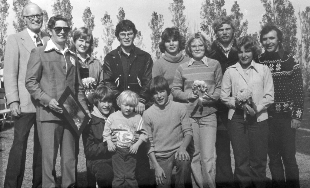 The Joe and Marge Gunn family was honored as SDSU's first Family of the Year at halftime of the Family Day game Oct. 13, 1979. Pictured, back row, from left, are SDSU President Sherwood Berg, patriarch Joseph Gunn (with plaque) and his children, Theresa, Steve, Mary (now Sieler), Jennifer (now Brynjulson), Paul, Diane (now Gildemaster), Studentsâ€™ Association President Jerry Schmitz. Kneeling, from left, Jeff, Patrick and Scott. Not pictured are the mother, Marjorie, who was in Huron conducting a South Dakota Federation of Garden Clubs state meeting, and sister, Deb, who was in Washington, D.C., working for the Department of Health, Education and Welfare.