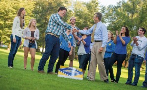 President David Chicoine competes against Studentsâ€™ Association President Caleb Finck in a beanbag toss event at the Coolidge Sylvan Theatre. Chicoine, who announced his plans to step away from being the university president in December, defeated Finck.