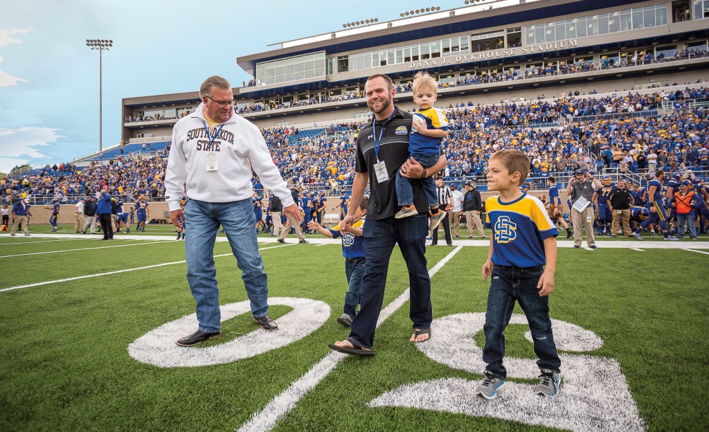 Thank you Dana: Dana J. Dykhouse, at left, is joined by his son and grandchildren before the coin toss. Dykhouse was honored at halftime for his contributions to the Dana J. Dykhouse Stadium.