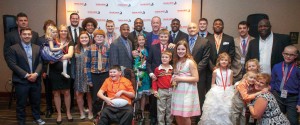 Children with brain tumors, former Huskers and keynote speaker and cancer survivor Jim Kelly (center, back) gather at the 2016 Team Jack Gala.