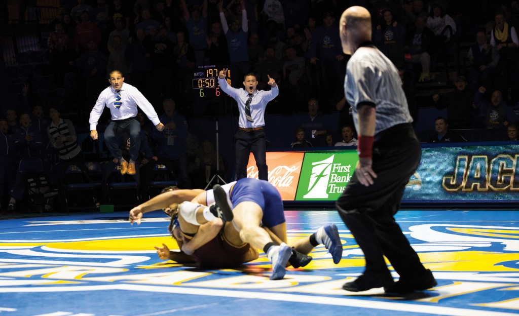 SDState wrestling coach Chris Bono reacts at a wrestling match.