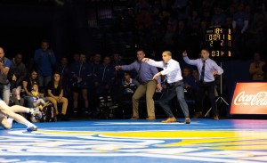 Wrestling coach Chris Bono gestures wildly during a match.