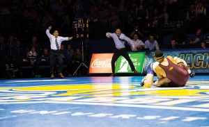 Wrestling coach Chris Bono yells during a match.