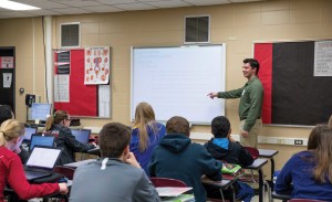 A teacher stands in front of the class.