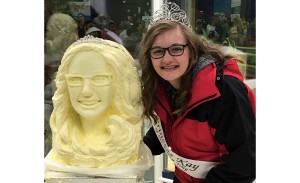 Rebekka Paskewitz poses with a statue of herself sculpted in butter.