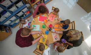 Preschool students work on a colorful craft project.
