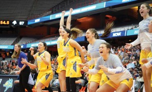 The women's basketball team cheers on their teammates from the sidelines. Photo by Charles Wainwright