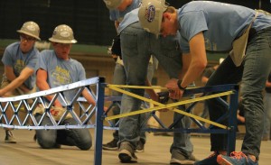 SDSU students work on building a steel bridge.