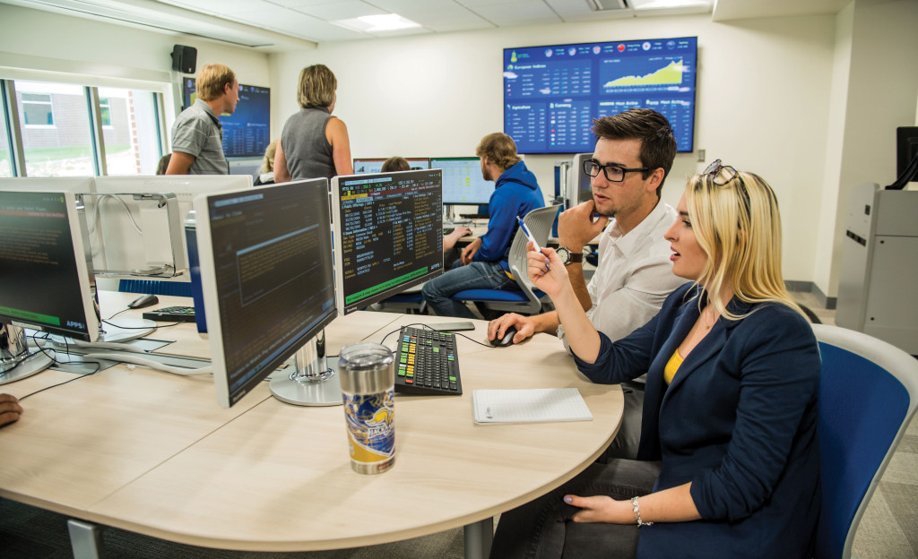 Students look at a computer in the e-trading lab on campus.