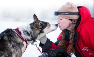 Greta Krafsur shares a nose-to-nose exchange with a sled dog.
