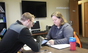 Lisa Strohschein â€™03 helps Jordan Steinle prepare for an interview by talking about his approach to a Kentucky airport. Strohschein, president of the aviation program's industry advisory board, likes working with students when her schedule with UPS allows. 