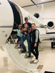Michael Dill â€™08 and family before a recent flight.