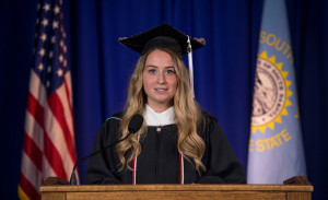 A woman speaks at a podium.