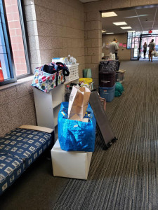 A pile of packing boxes and clothes waiting to move.