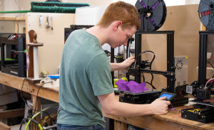 A man uses a 3D printer.