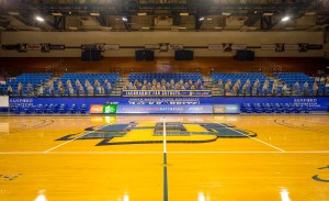 An empty basketball arena with cardboard cutouts in place of fans.