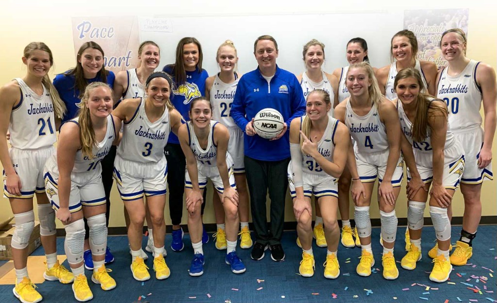 A female basketball team poses for a photo.