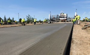 A construction crew lays concrete.