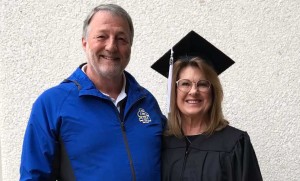 A graduate poses with her husband.