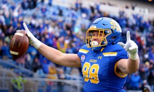 A football player points to the crowd.