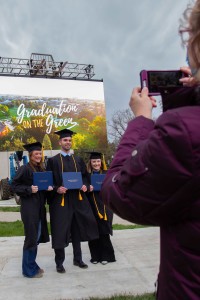 Three graduates pose for a photo.