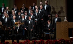 A men's choir performs.