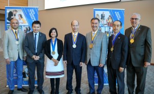 Several endowed faculty members wearing medals around their necks pose for a photo.