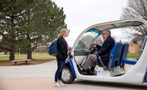 Barry Dunn offers a student a ride in his golf cart.