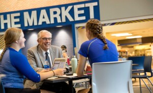 President Barry Dunn visits with students in the student union.