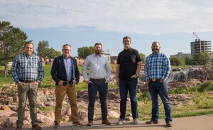 A group of construction professionals gather at Falls Park.