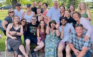 A group of theater alums pose for a group photo.