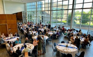 People sit at round tables at a banquet.