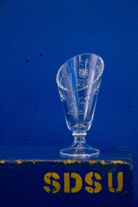 A glass vase with engraved words.