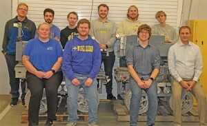 A group of engineering students pose with their winning machines.